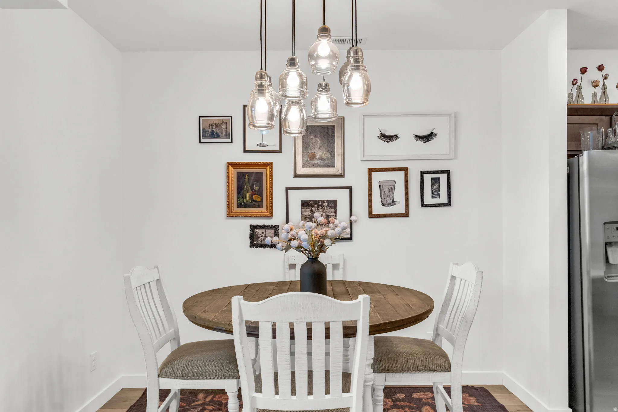 Dining area with five clear glass pendant lights