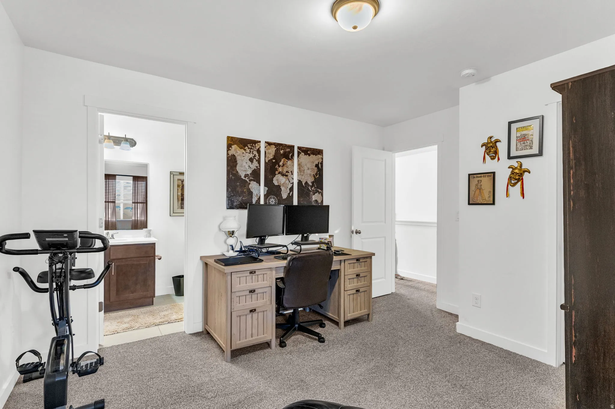 Carpeted room with white walls and a ceiling-mounted light fixture