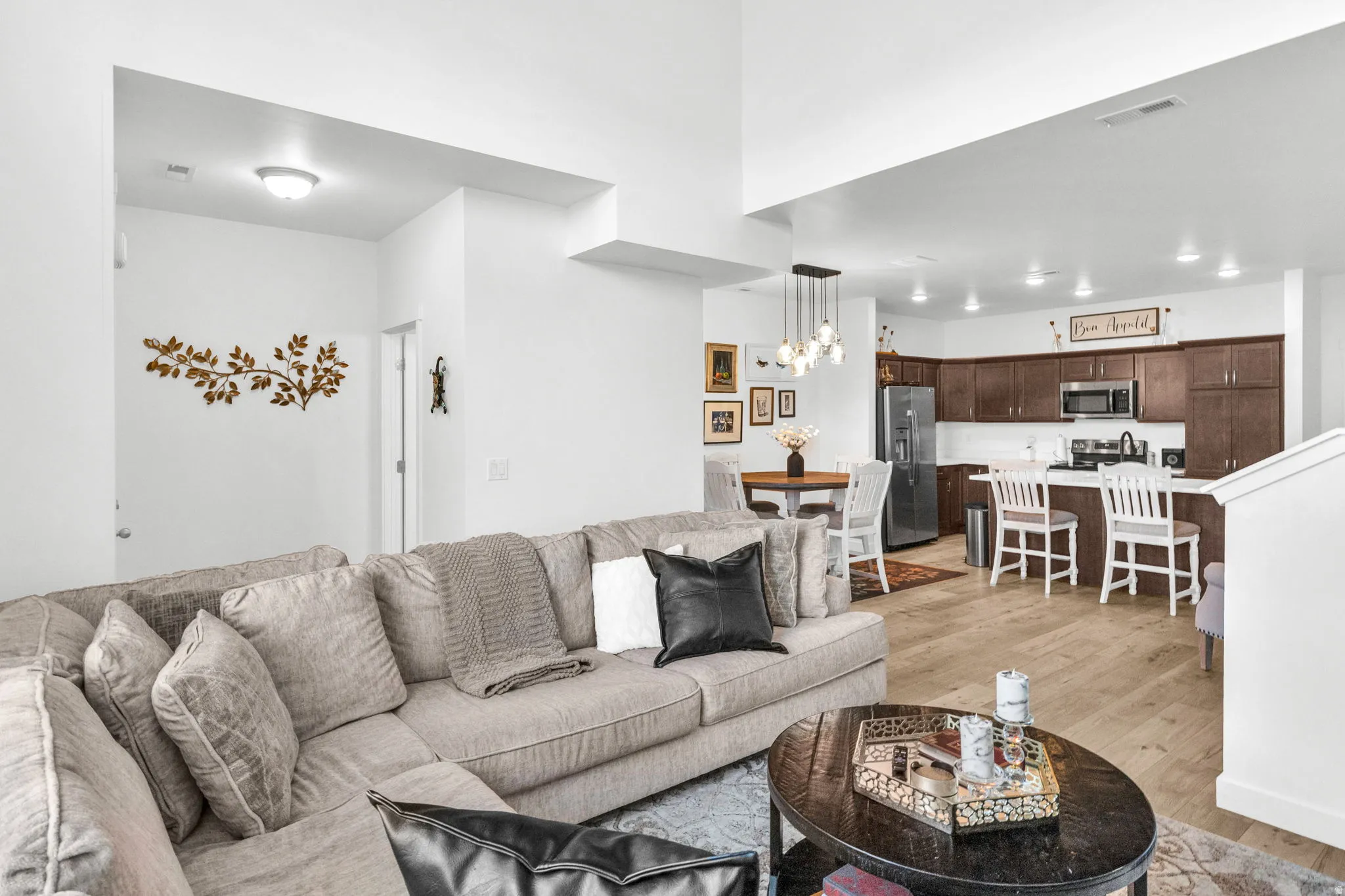Open-concept living area featuring light wood-finish flooring