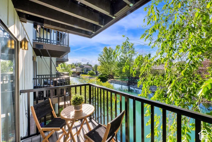 Private balcony featuring black railings and a water view