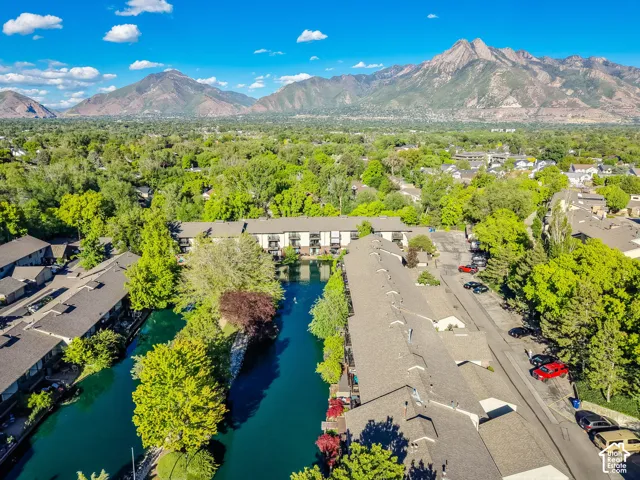 Community featuring a water channel, mature trees, and private balconies