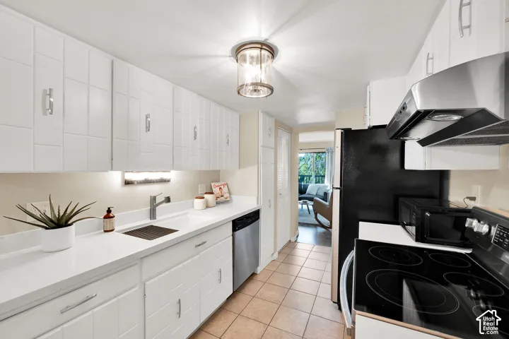 Kitchen featuring white cabinetry, quartz countertops, a stainless-steel appliances