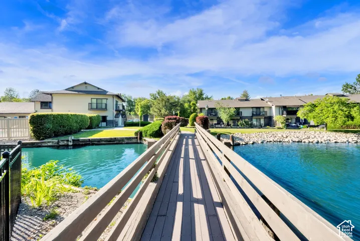 Expansive wooden walkway extending over a vibrant blue waterway