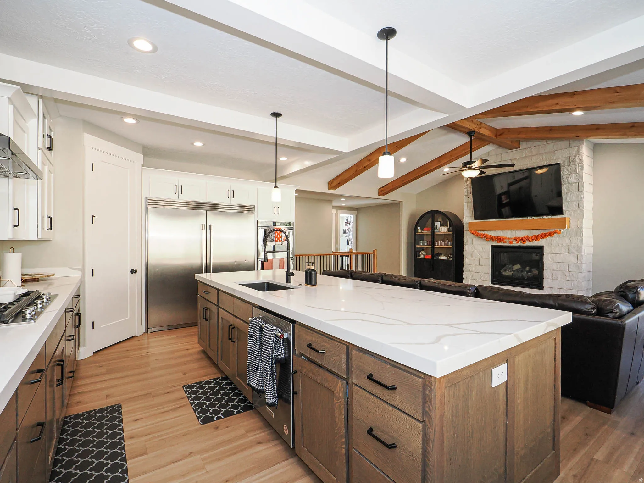 Expansive kitchen island with a light-toned countertop and integrated sink