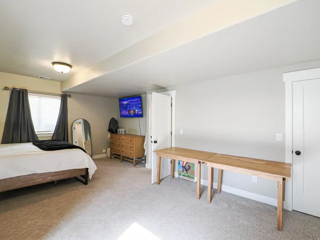 Carpeted room featuring light-colored walls and white trim