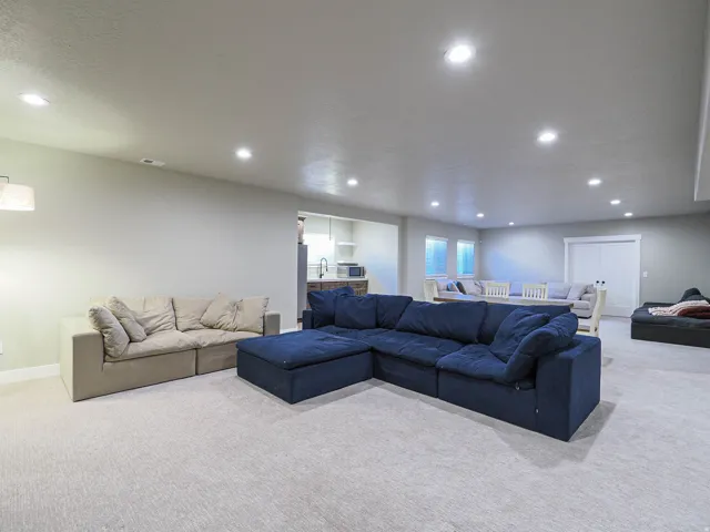 Spacious carpeted room featuring recessed lighting and light gray walls