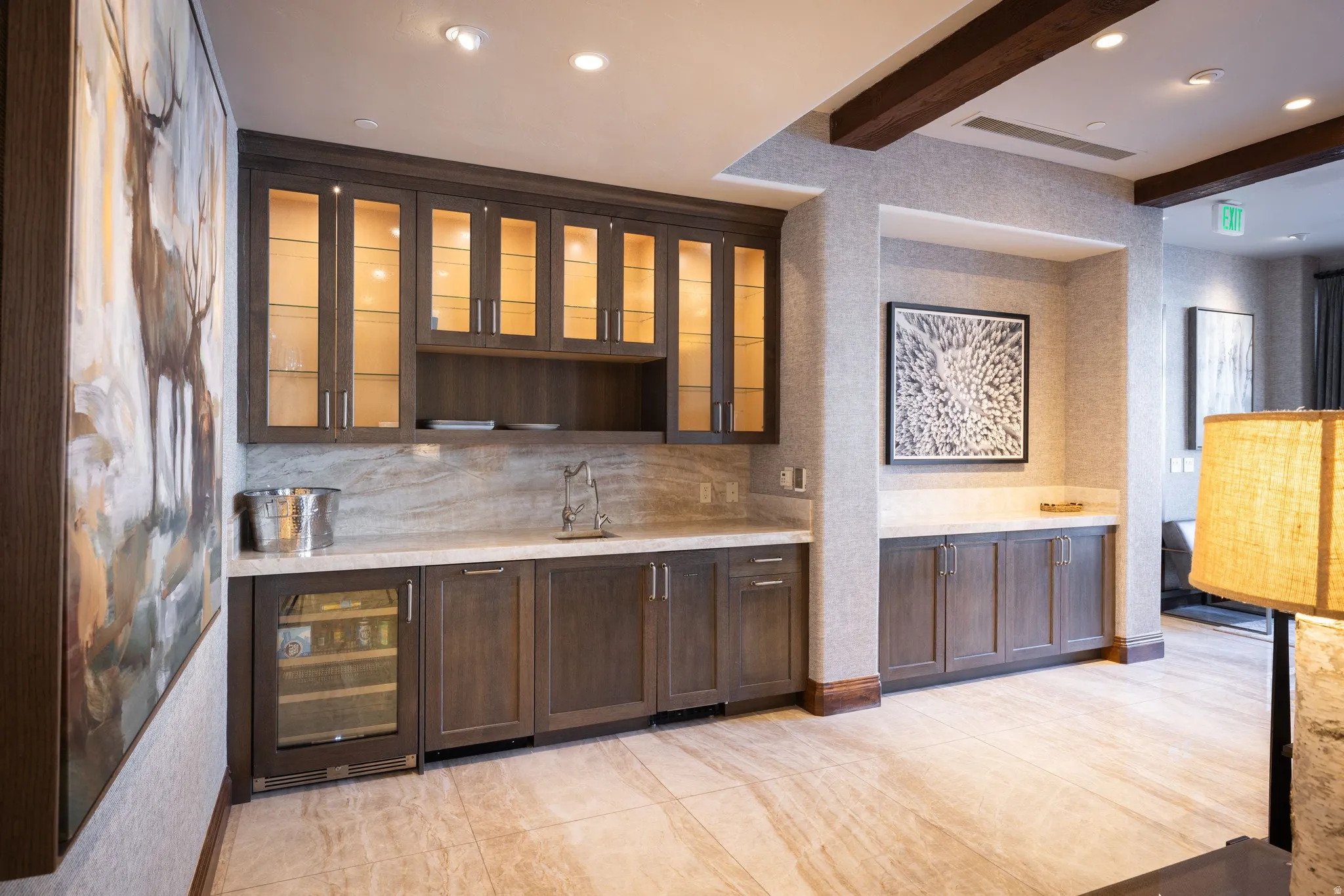 Built-in wet bar featuring dark wood cabinetry, integrated wine cooler, stone countertop, and matching stone backsplash