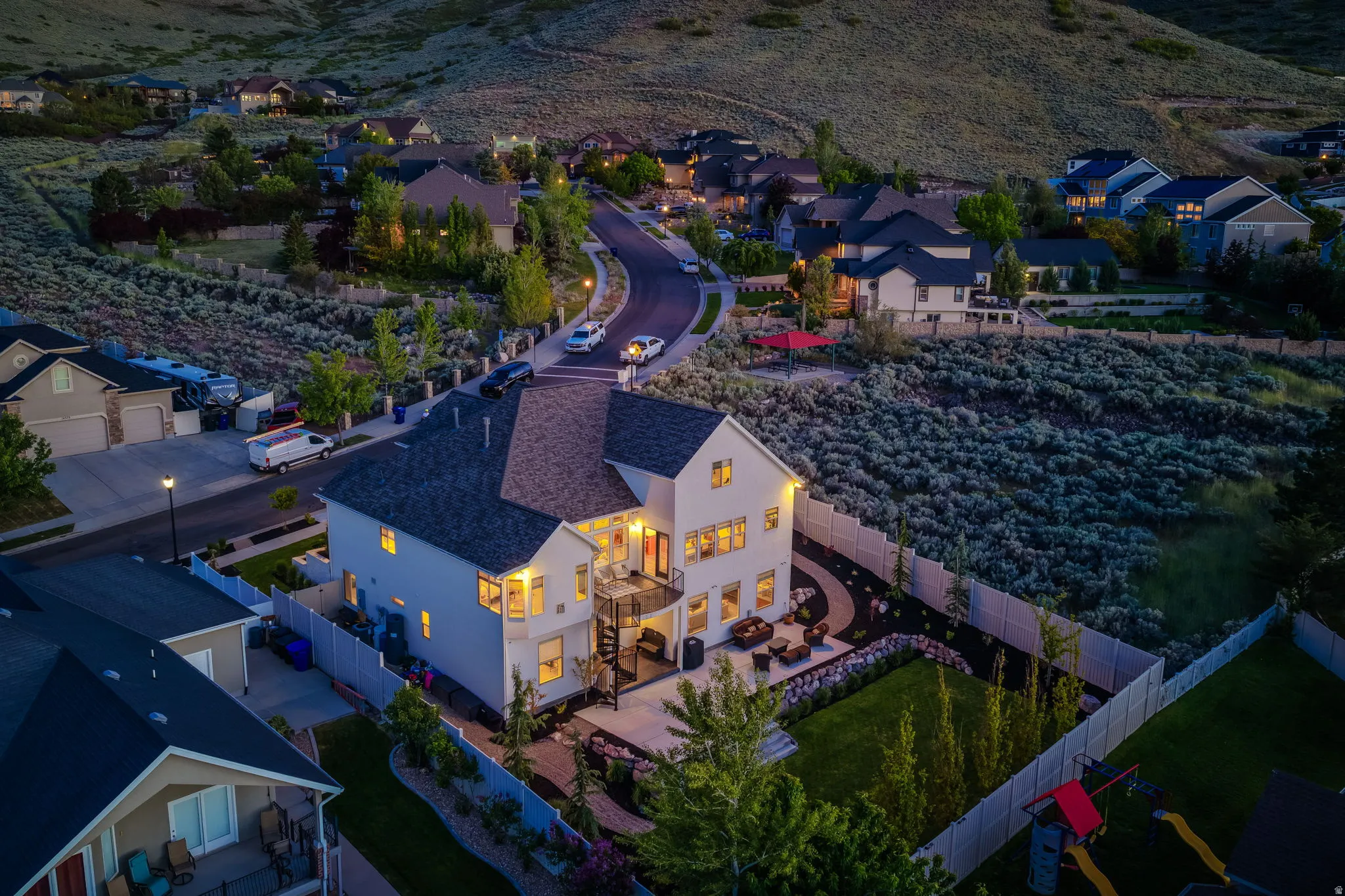 Contemporary residence featuring a light-toned exterior and dark shingle roofing