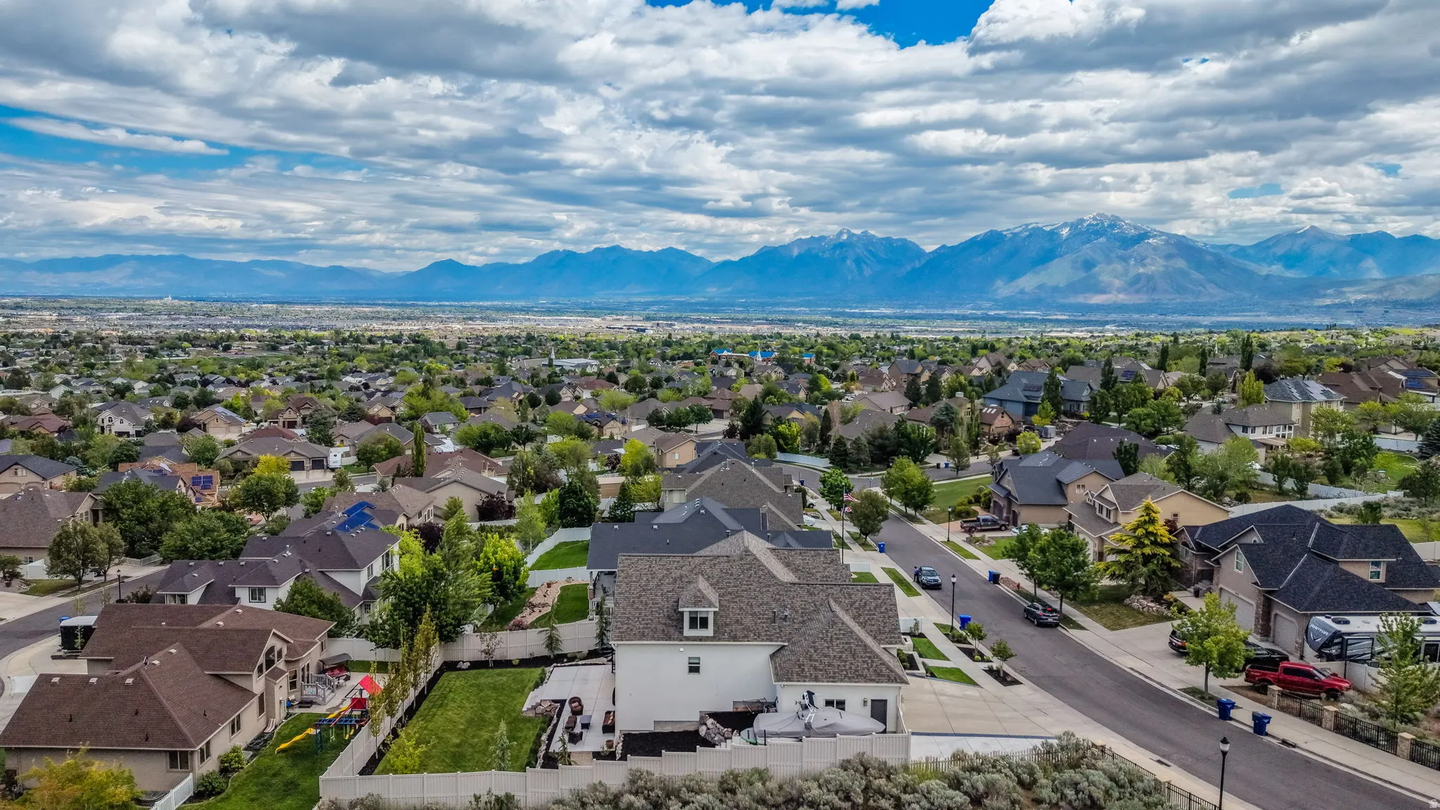 Expansive neighborhood setting featuring numerous residential properties and a distant mountain range backdrop