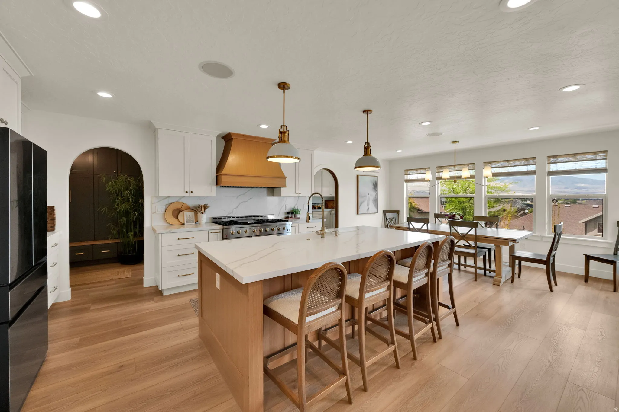 Open-concept kitchen and dining area featuring a spacious island with seating