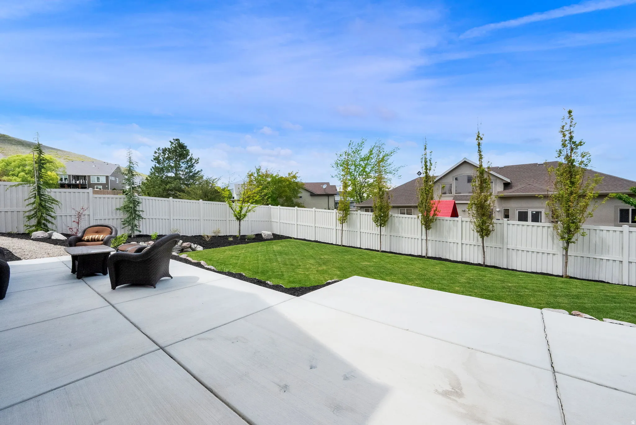 Expansive concrete patio offering a dedicated outdoor living space