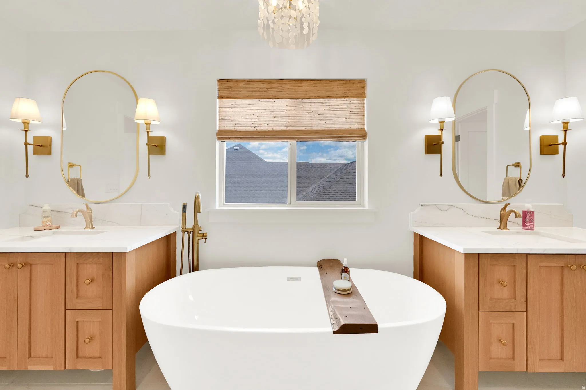 Freestanding soaking tub with a floor-mounted brass faucet