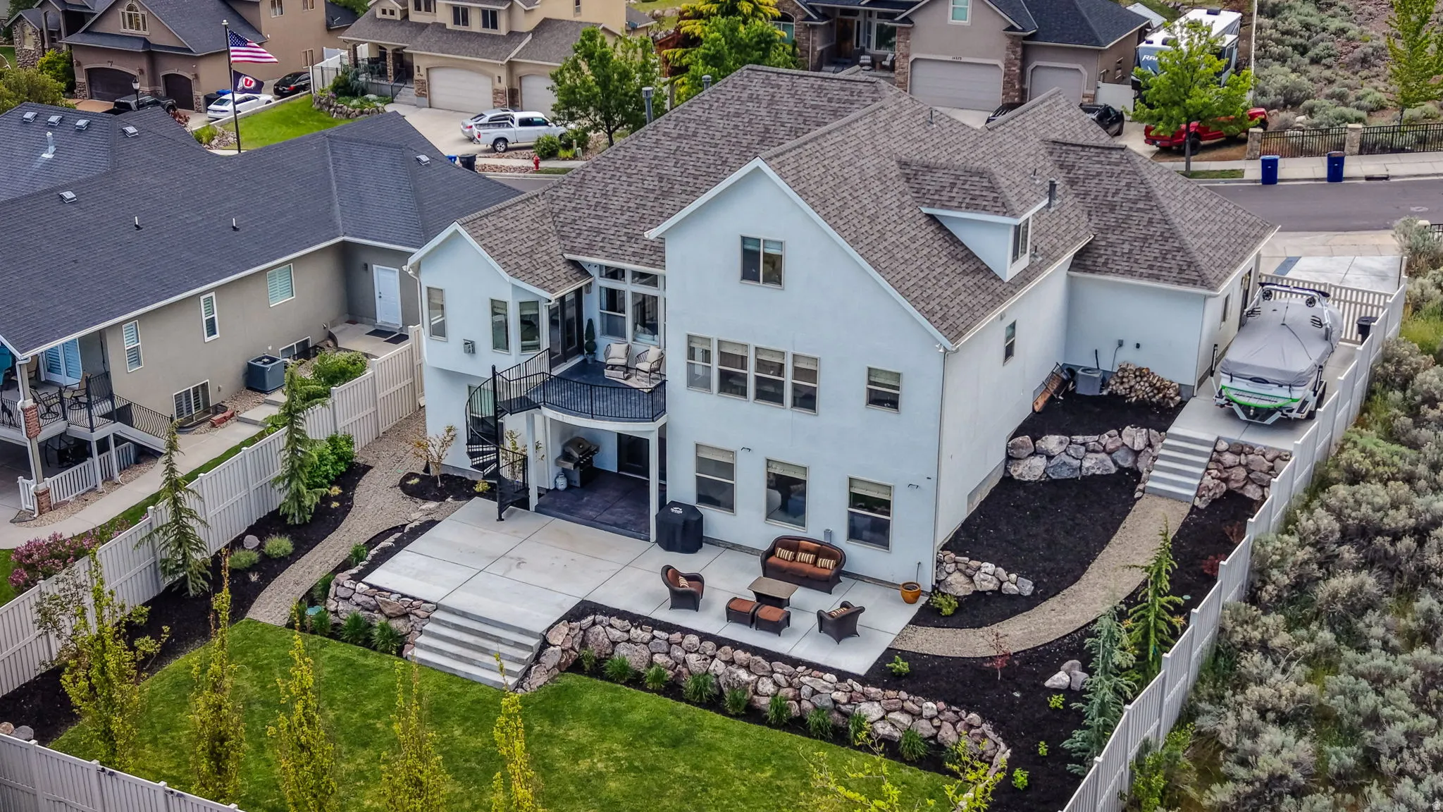Multi-level exterior featuring a light-colored facade and a dark shingle roof