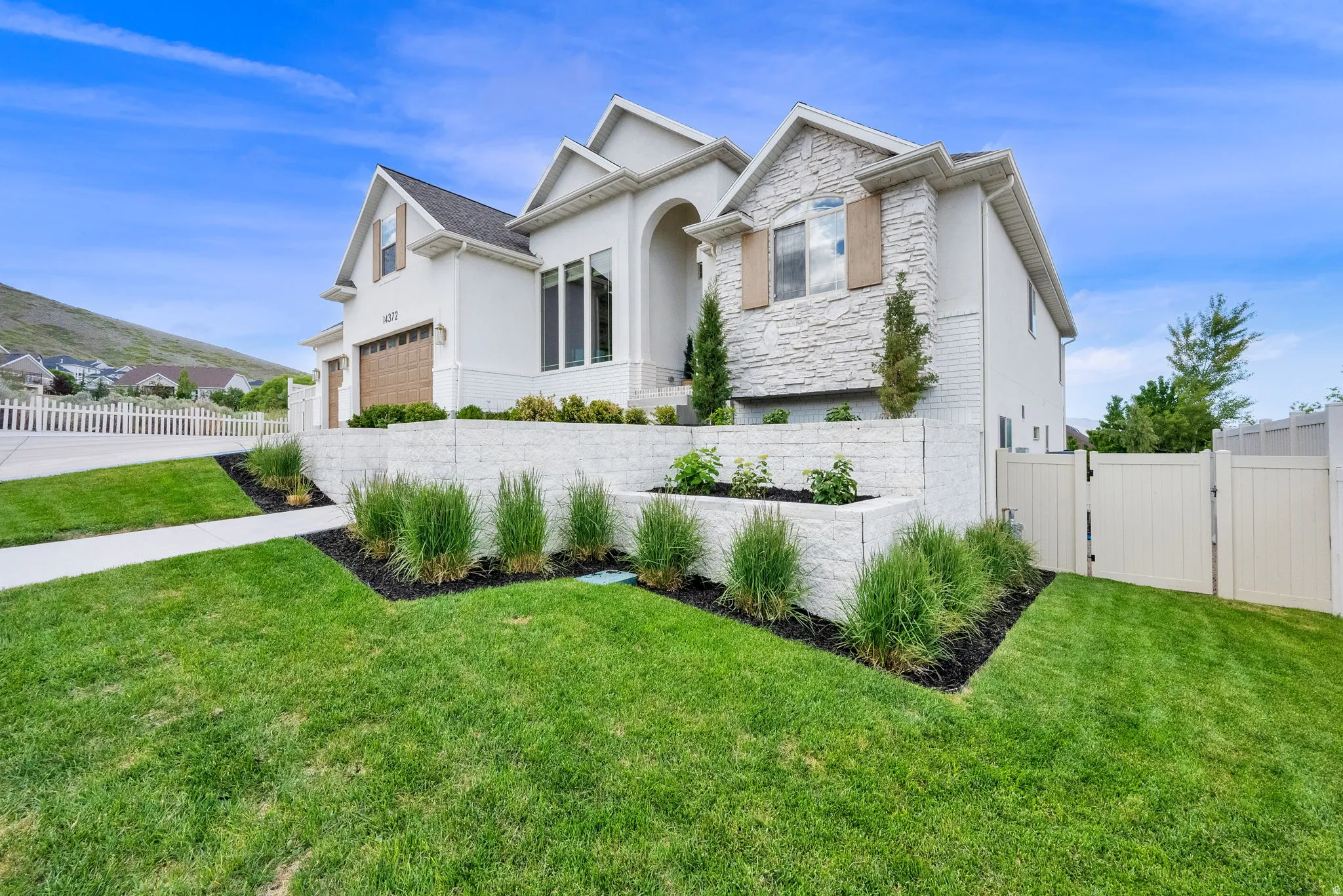 Contemporary two-story residence featuring a combination of stucco and stone exterior finishes