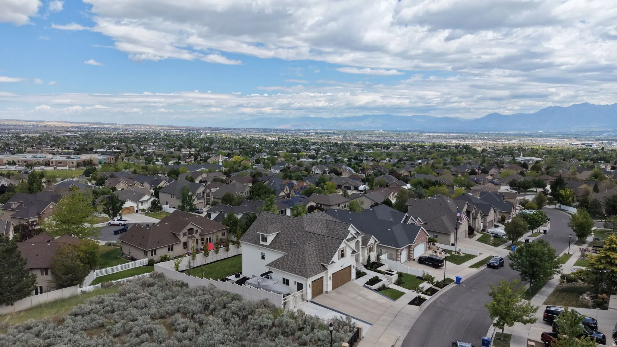 Suburban neighborhood featuring established residential properties, mature landscaping, and curved street designs