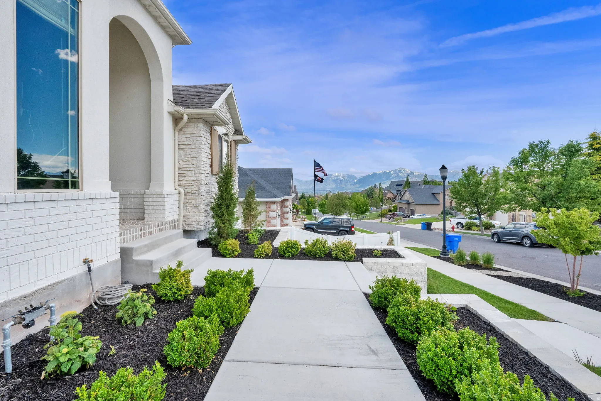 Contemporary exterior featuring white brick and stone accents