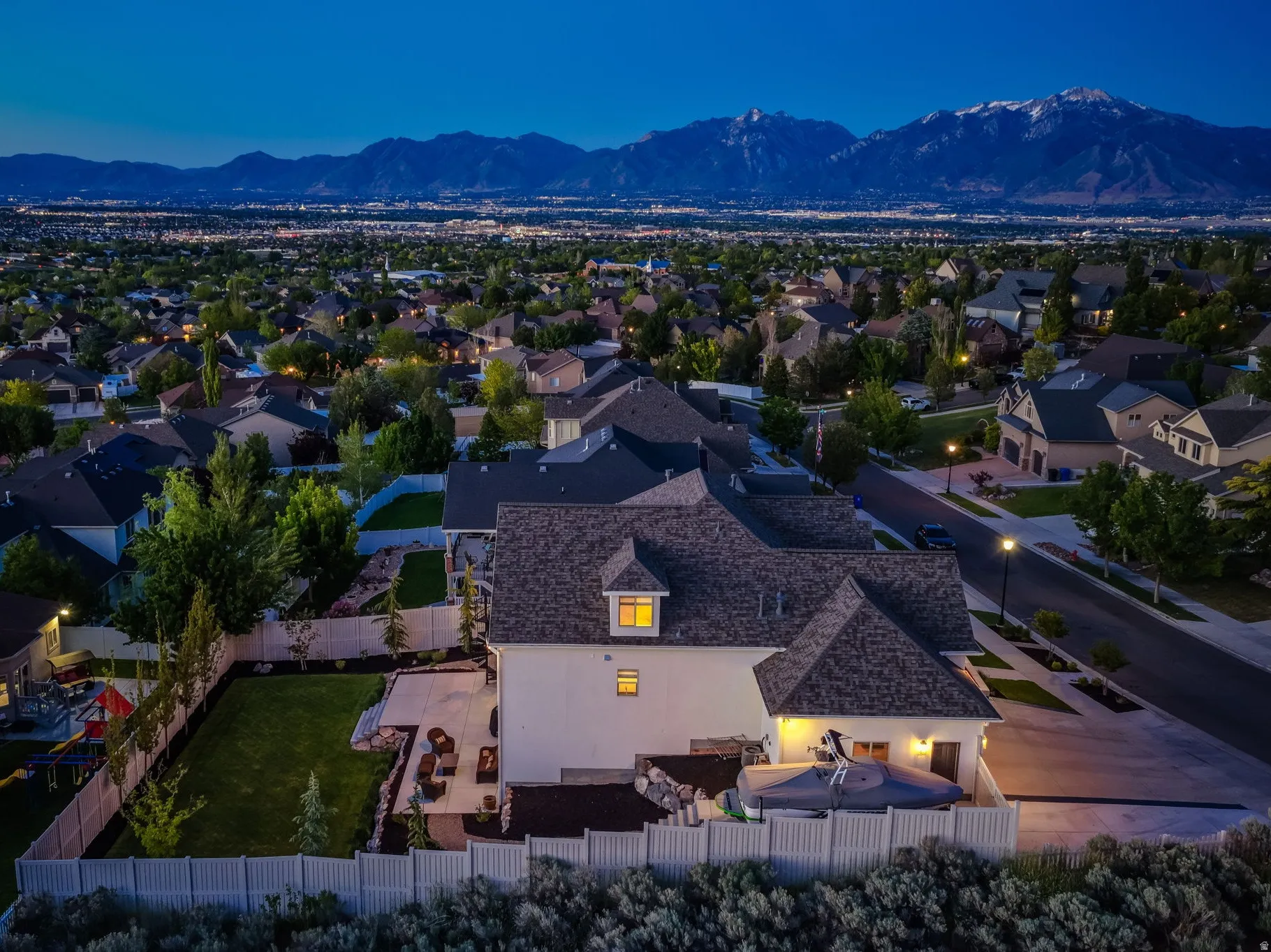 Aerial perspective showcasing a residential neighborhood with distant mountains