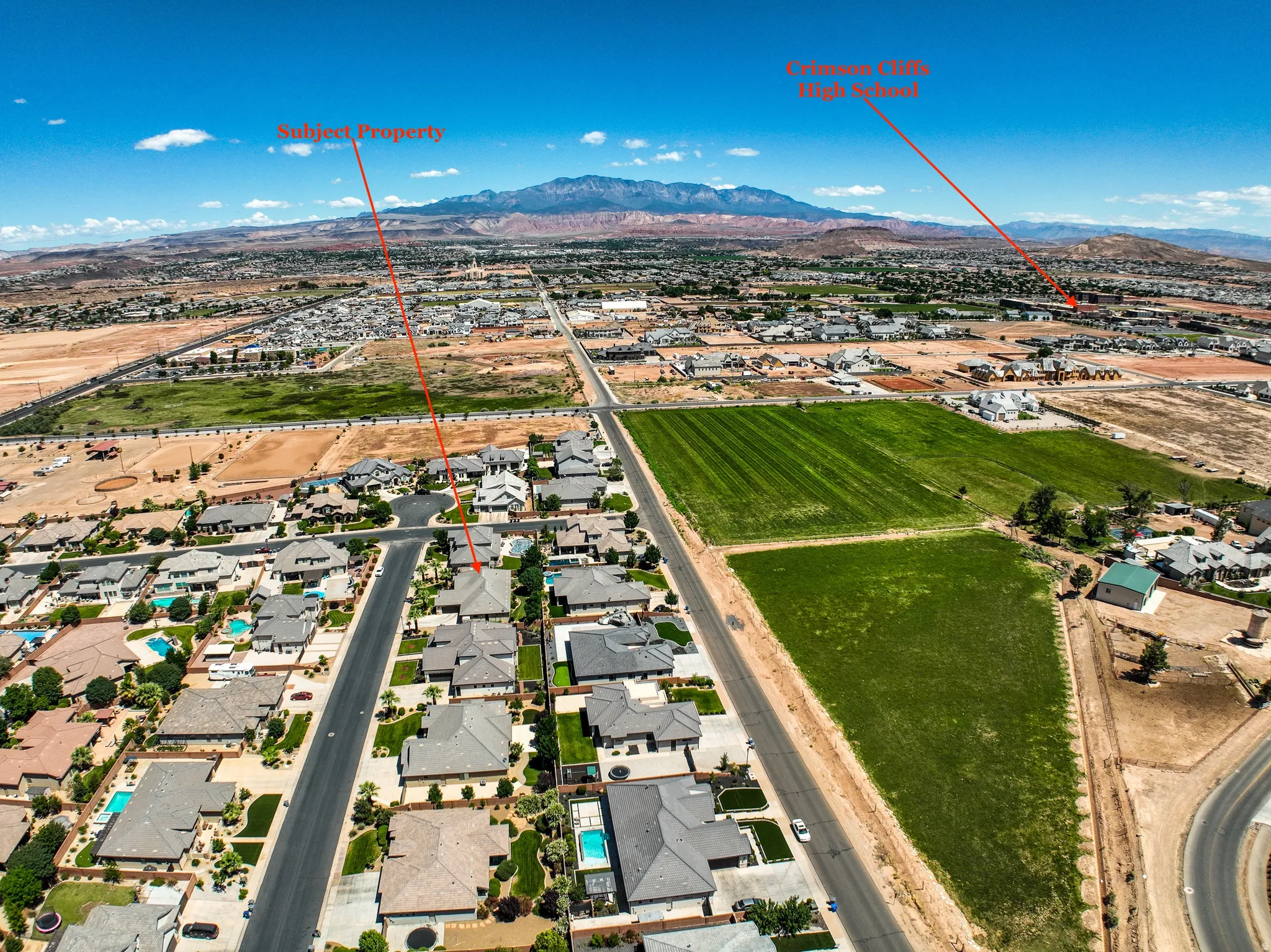 Aerial perspective showcasing a residential neighborhood with distant mountainous terrain