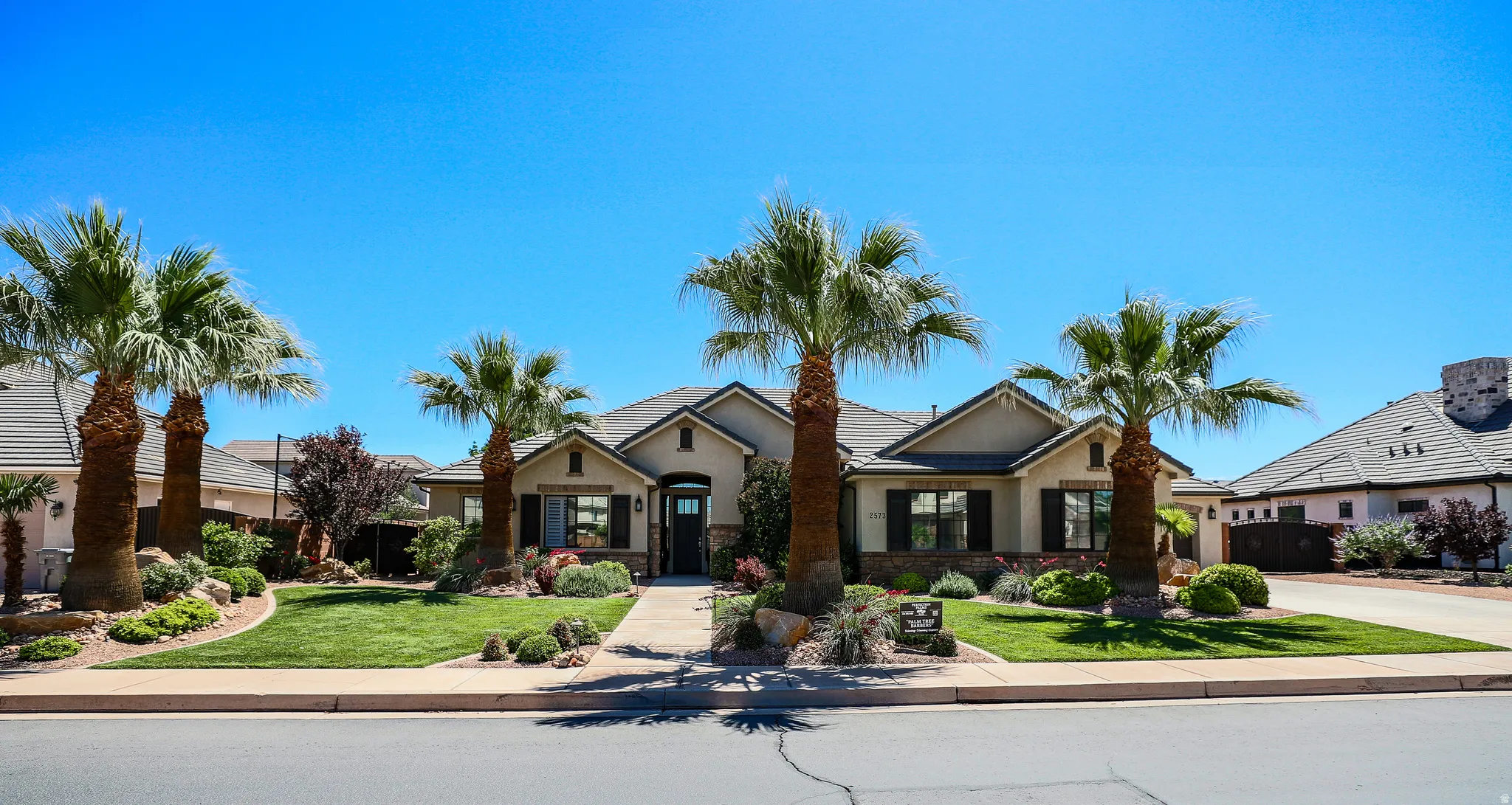 Single-story residence featuring a stucco exterior with stone accents and a dark-toned roof