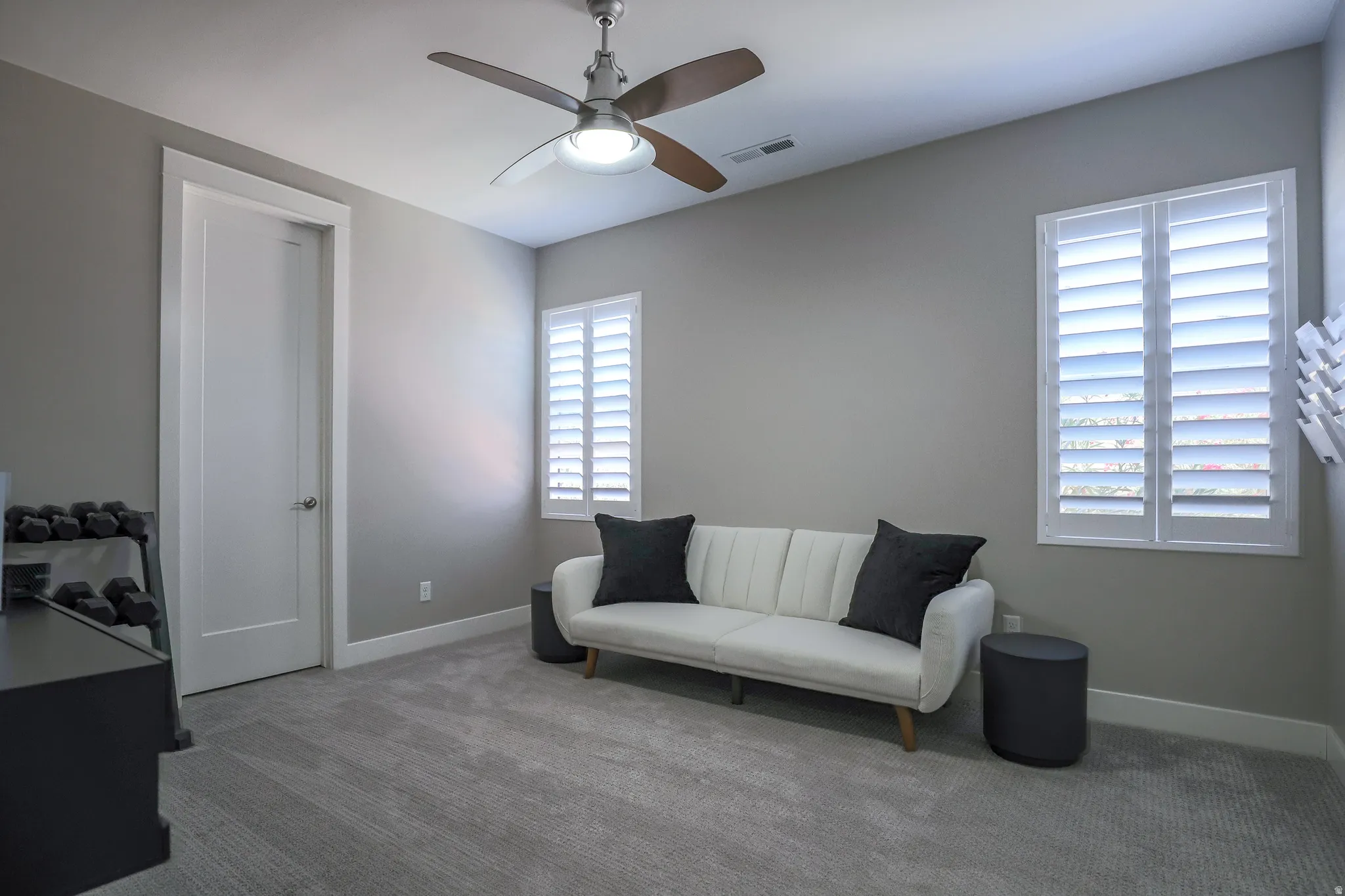 Room featuring light gray walls, gray carpet, and white trim
