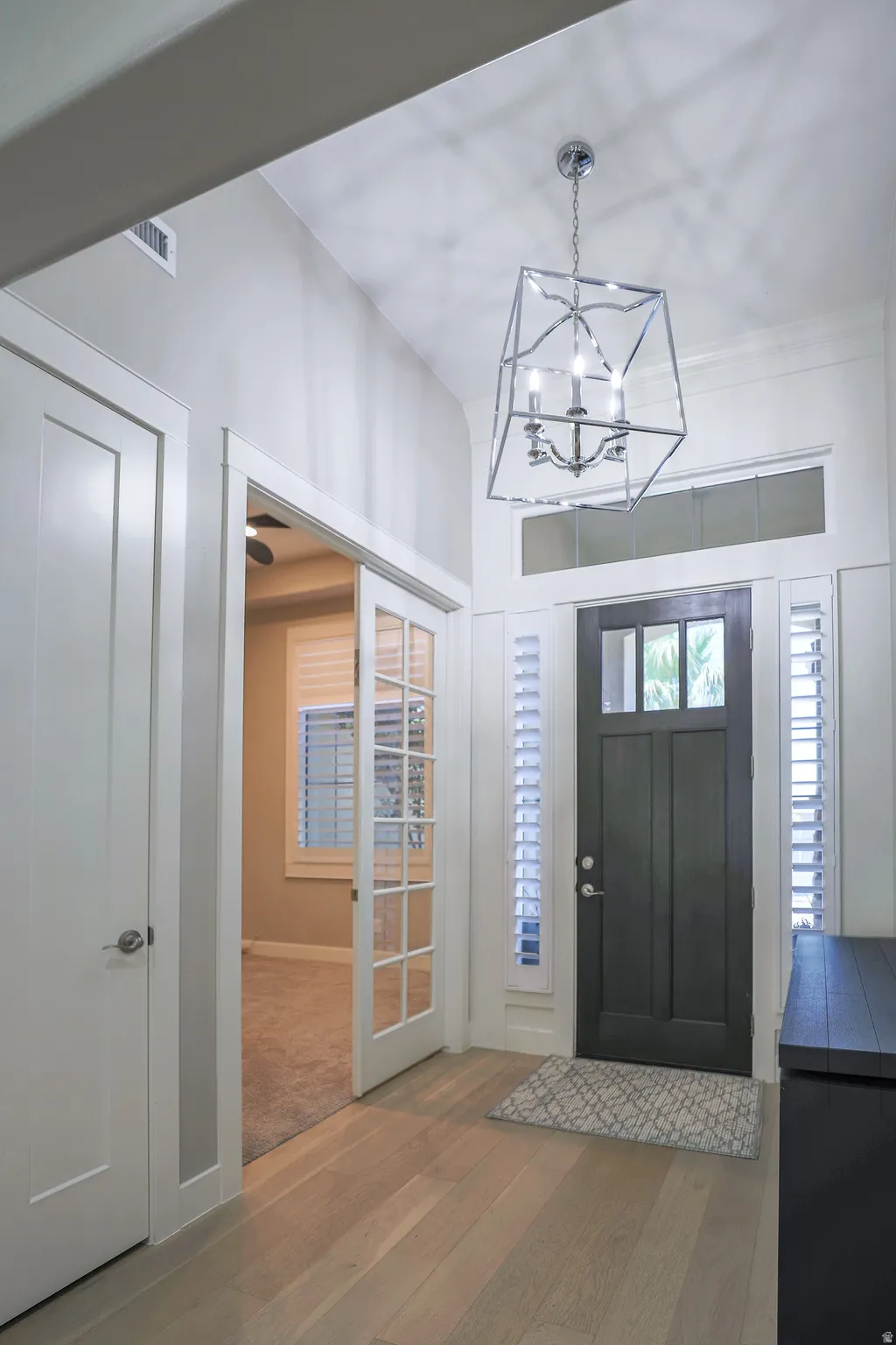 Entryway featuring vaulted ceilings and light wood-finish flooring