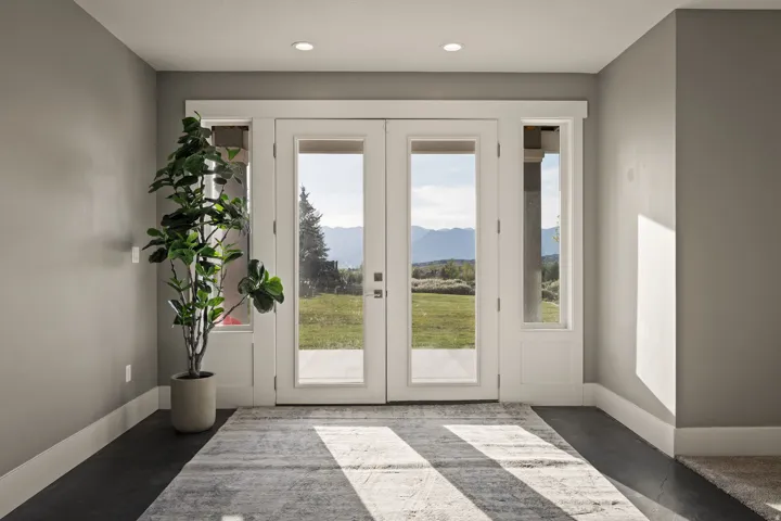 Double French doors with sidelights opening to a landscaped property