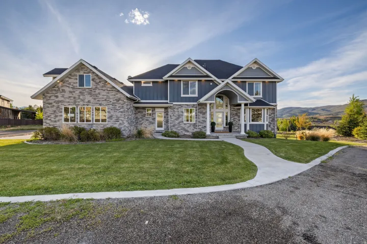 Distinguished two-story residence featuring a stone and siding exterior