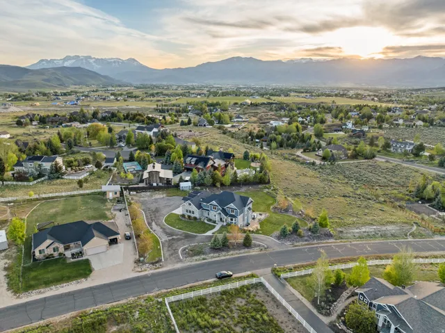 Expansive aerial view showcasing a suburban residential area with distant mountain ranges