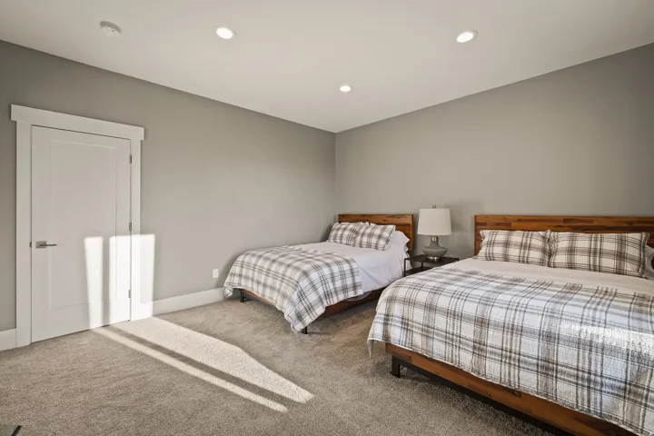 Carpeted room featuring a white paneled door with trim, recessed lighting, and neutral wall paint