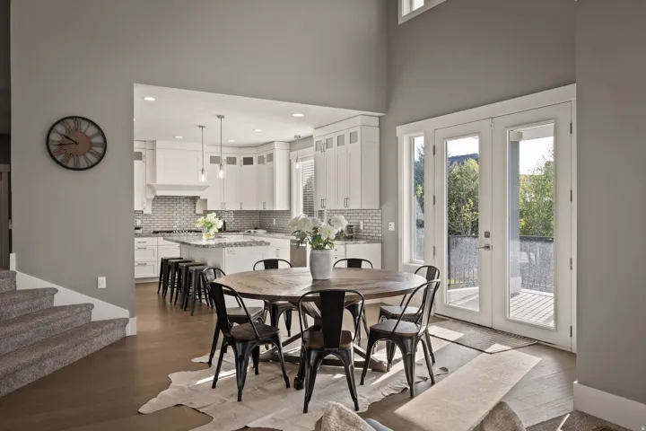 Two-story living area with wood-finish flooring and a carpeted staircase