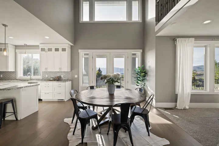 Open-concept living area with high ceilings and wood-finish flooring