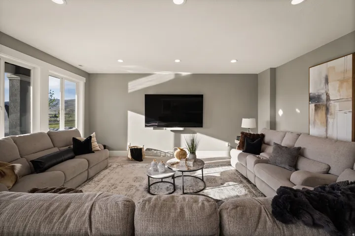 Spacious living area featuring light gray walls and recessed lighting