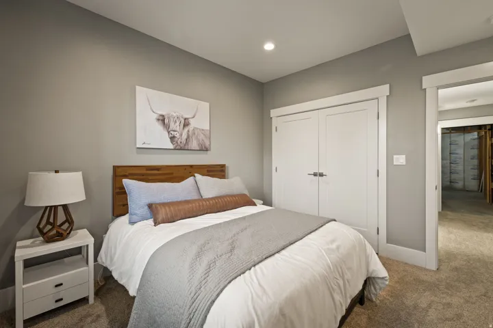 Bedroom featuring neutral gray walls and a wood-finish headboard