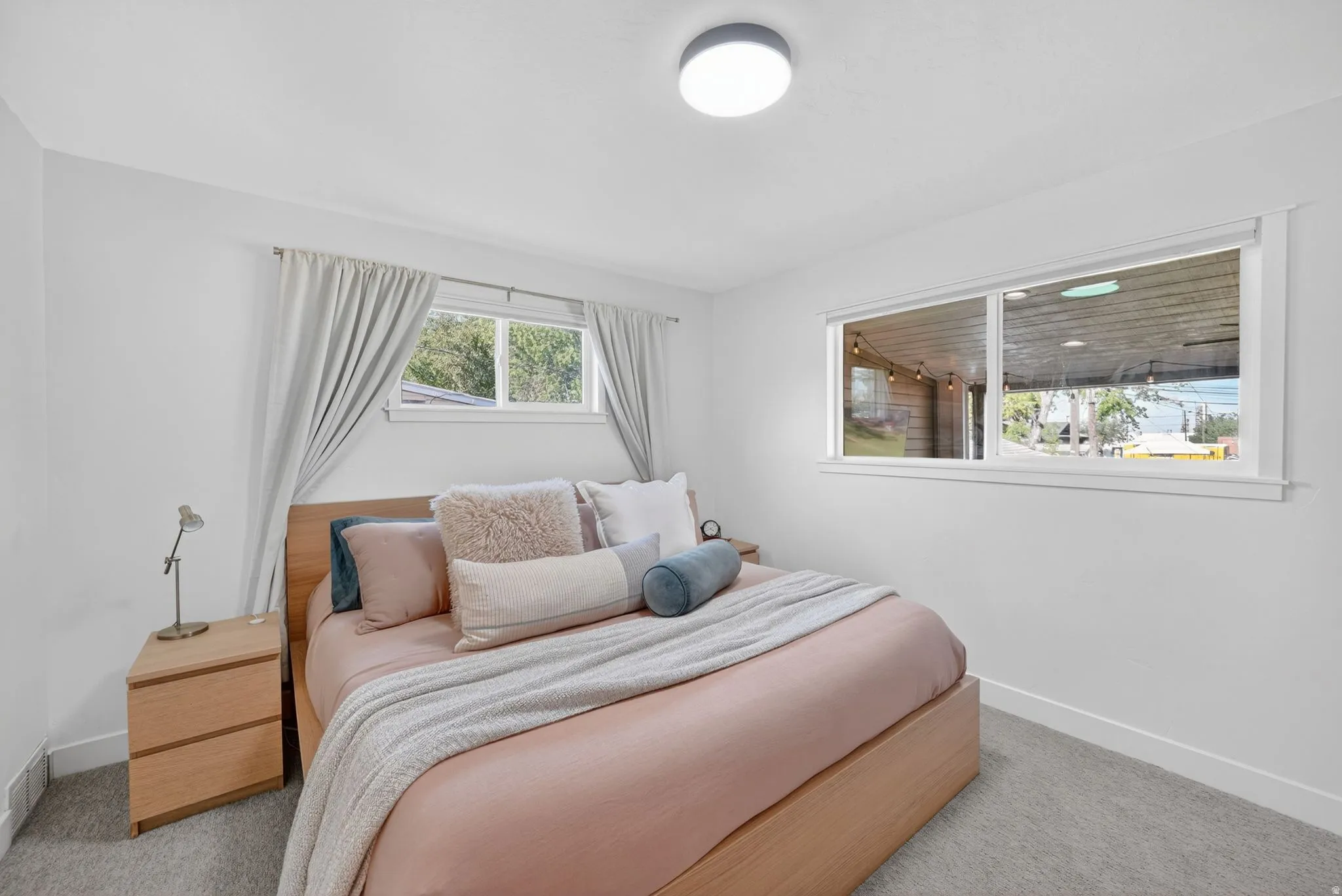 Bright room featuring white walls and a contemporary flush-mount ceiling light