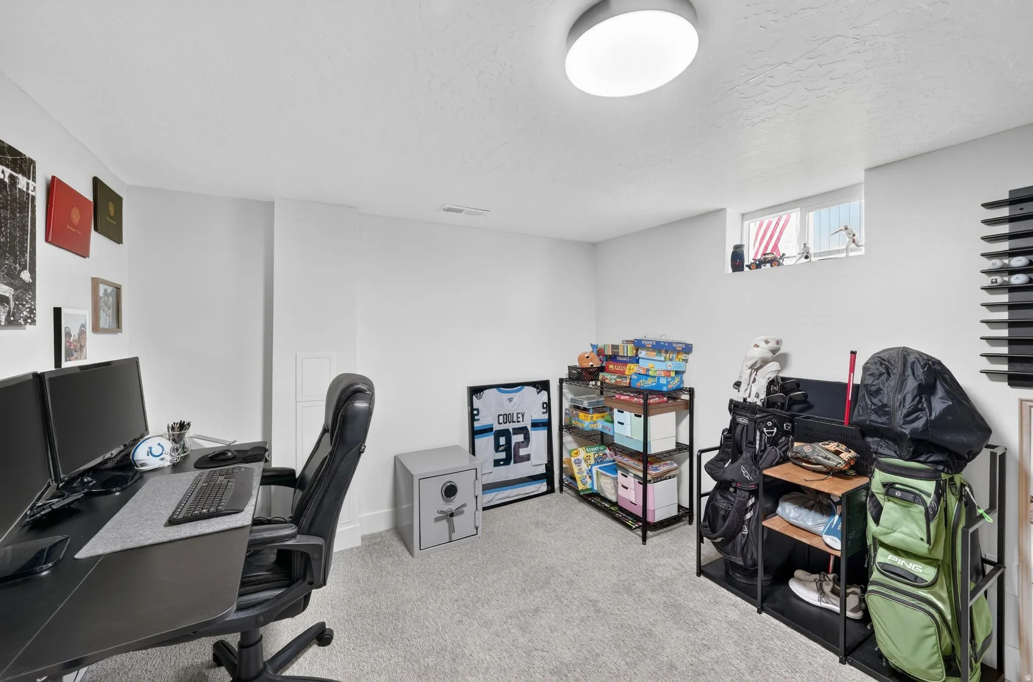 Carpeted room featuring a ceiling-mounted light fixture and a single window
