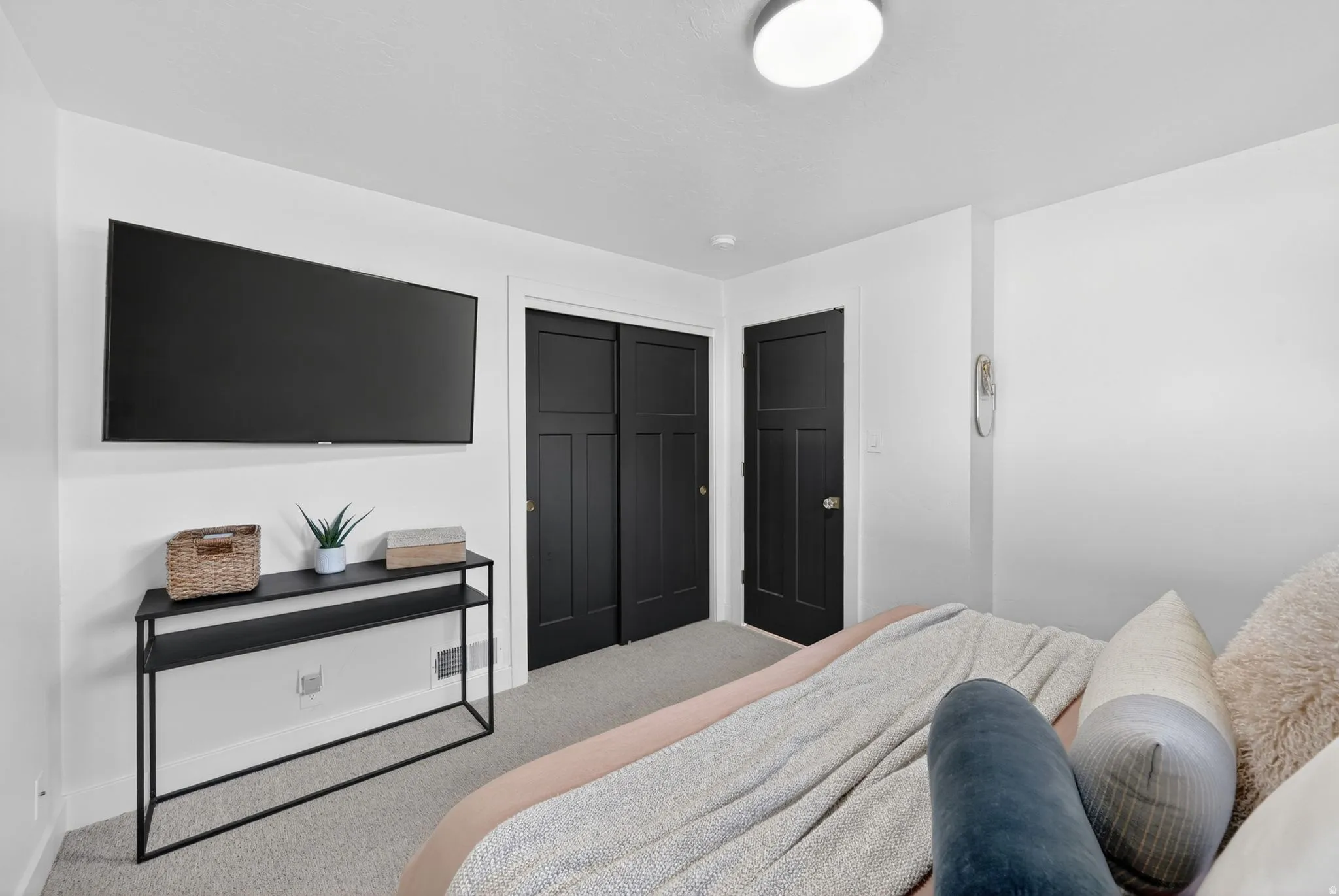 Interior space featuring neutral wall tones and grey carpeting