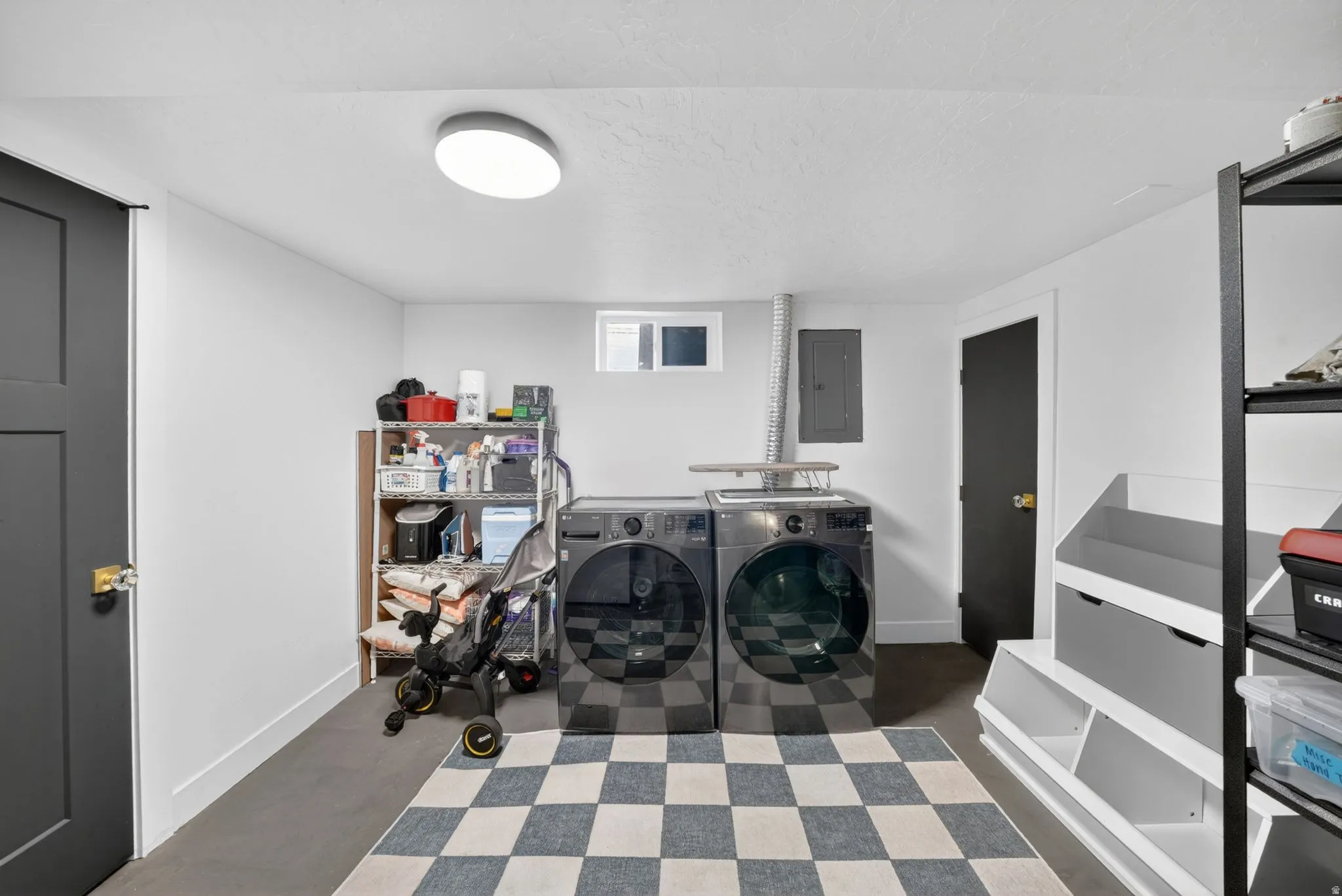 Dedicated laundry area featuring a flush-mount ceiling light and a small egress window