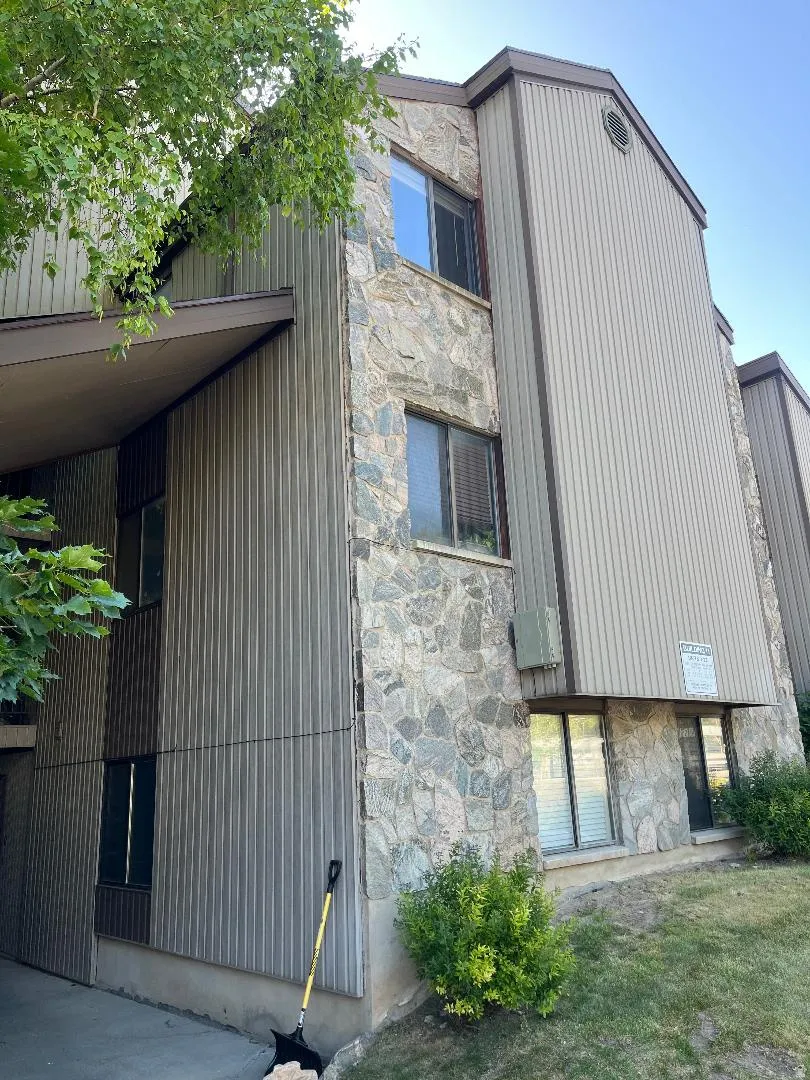 Multi-level structure featuring a stone and vertical siding exterior