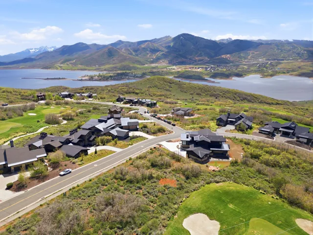 Aerial overview showcasing multiple properties with lake and mountain scenery