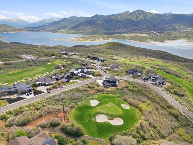 Expansive golf course setting featuring manicured greens and sand traps