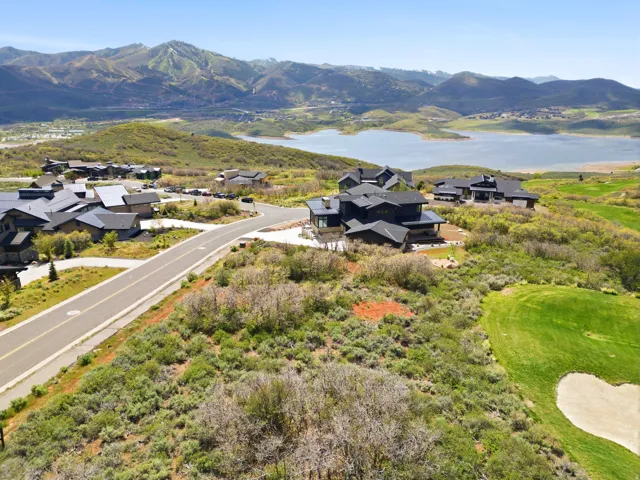 Contemporary-style residence featuring a dark exterior, multiple rooflines, and a paved driveway