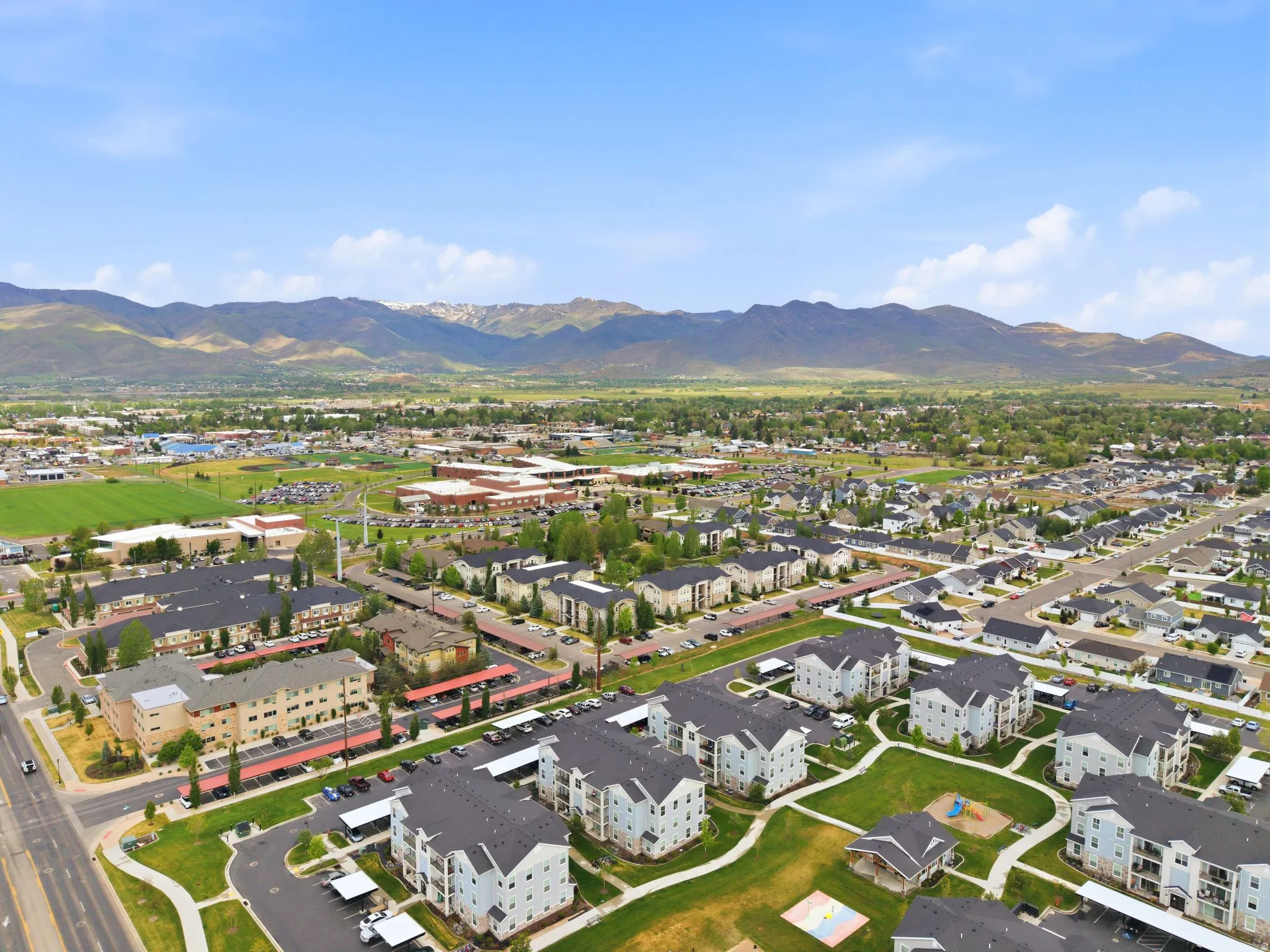 Aerial perspective showcasing a residential community with multi-story buildings and single-family homes