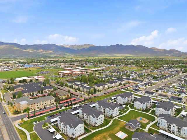 Aerial perspective showcasing a residential community with multi-story buildings and single-family homes