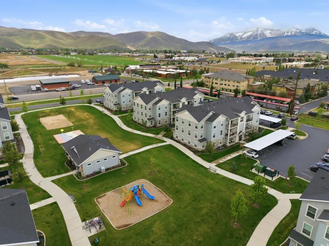 Expansive community green spaces featuring walking paths, mature landscaping, and covered parking structures