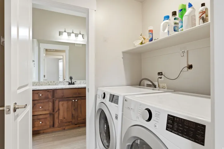 Dedicated laundry area featuring a built-in shelf and connections for appliances