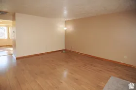 Wood-finish flooring throughout, complemented by light-toned wall finishes and wood baseboards