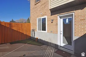 Brick exterior with a white framed door and a sliding window