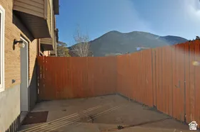 Private outdoor patio area featuring a wooden privacy fence