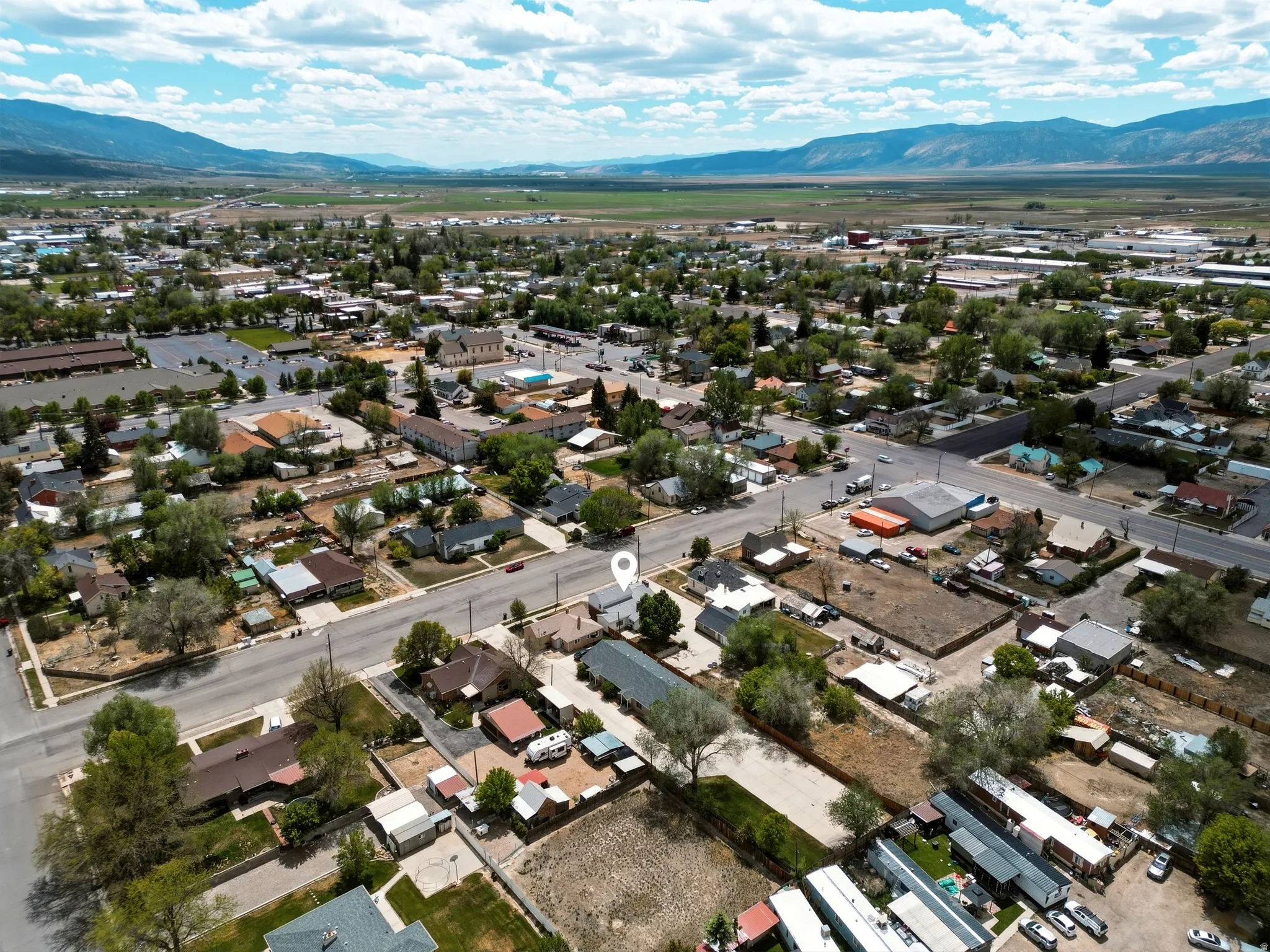 Aerial perspective showcasing a mixed-use neighborhood with residential and commercial properties