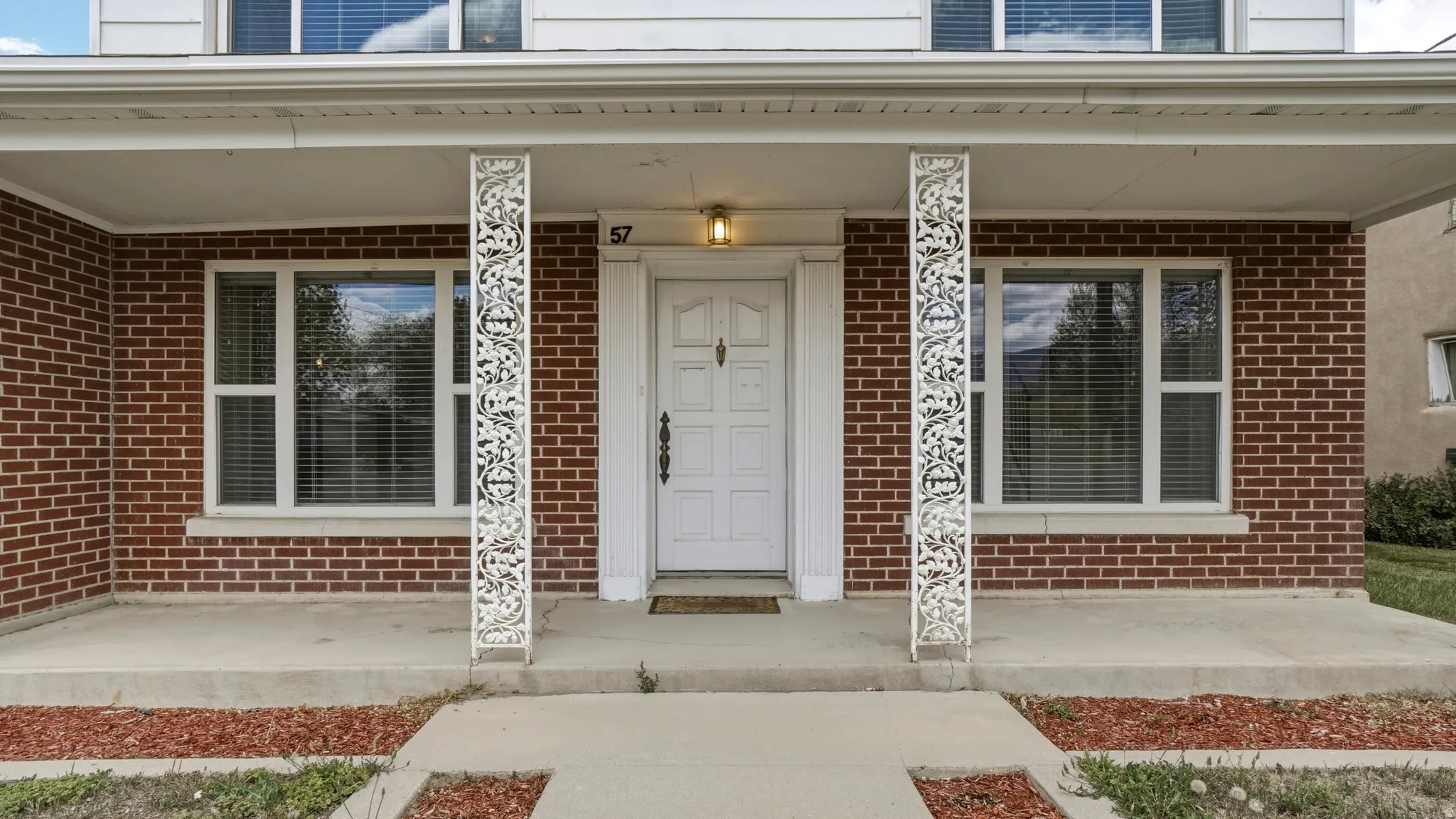 Red brick facade with a covered front porch